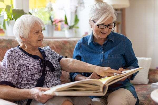 memory-care-senior-women-reading-photo-album-3